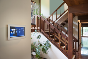 Programmable thermostat on the wall inside a home.